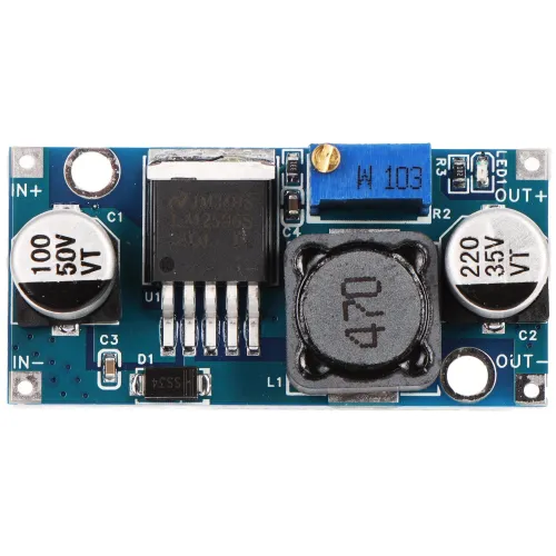 Zdjęcie przedstawia moduł elektroniczny z widocznymi kondensatorami, potencjometrem i cewką indukcyjną na niebieskiej płytce drukowanej. Elementy są oznaczone symbolami i wartościami, a całość jest sfotografowana z góry.